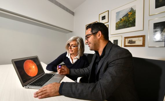CEO Eliav Shaked shows the RetiSpec technology to an older adult
