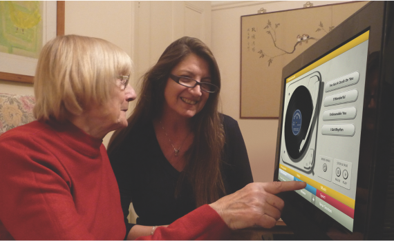 Senior woman and young woman looking at a computer screen