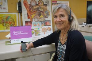 Audiologist Marilyn Reed hold an amplification device in her office