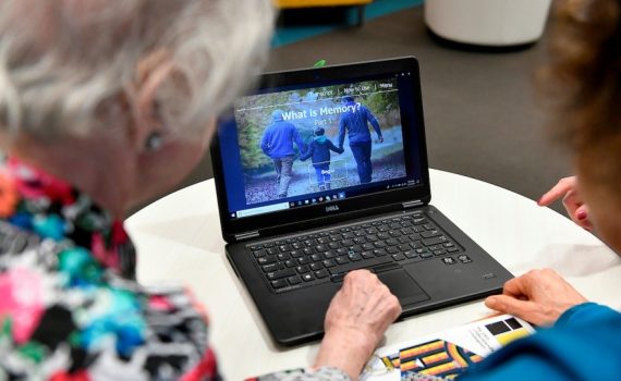 Older adults looking over health information at a laptop