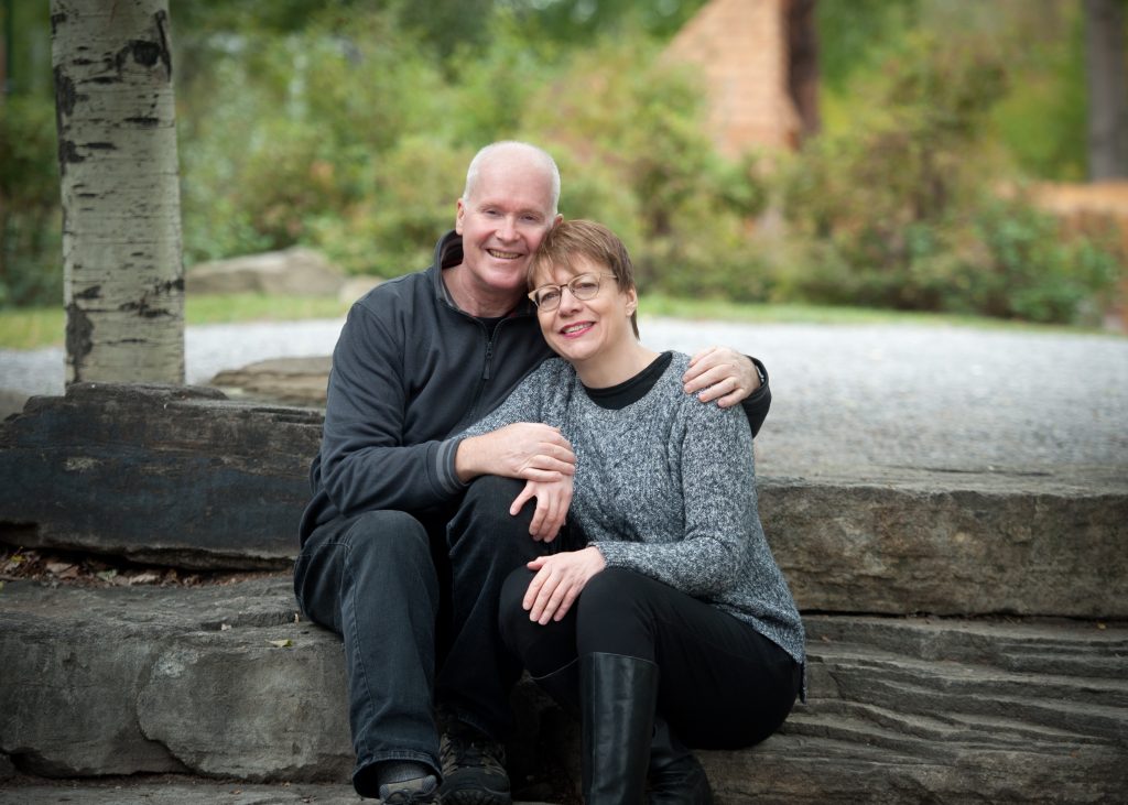 John and Cindy McCaffery sit together out in a nature setting