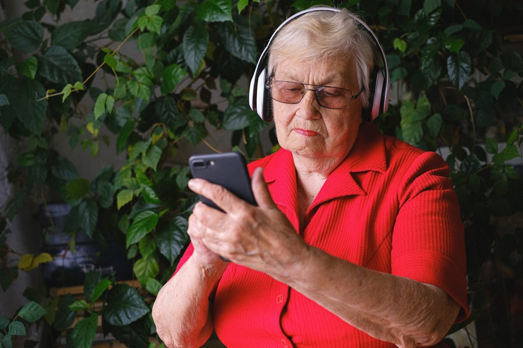 Senior woman listening to music on her phone