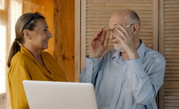 Older adult man and woman laughing together