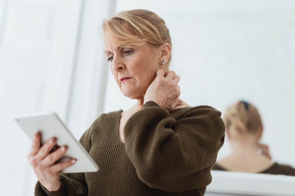 Older adult woman looking into at a tablet