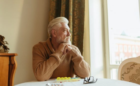 Older adult man staring into the distance