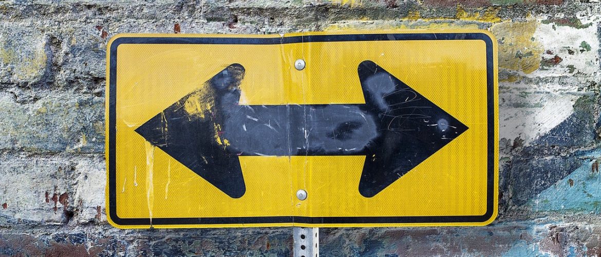 Road sign with arrows pointing in multiple directions