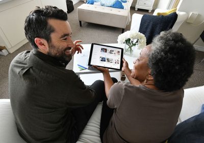 Image of two people looking at tablet
