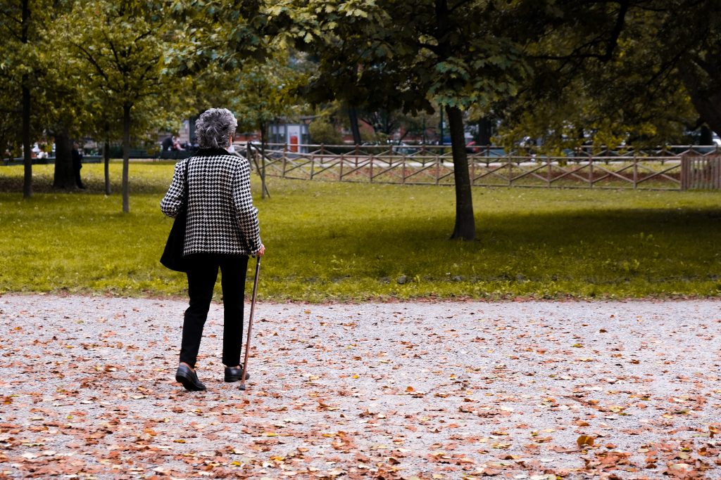 Woman walking in the park with a walker